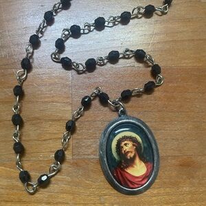Vintage black beaded necklace with Jesus disc pendant